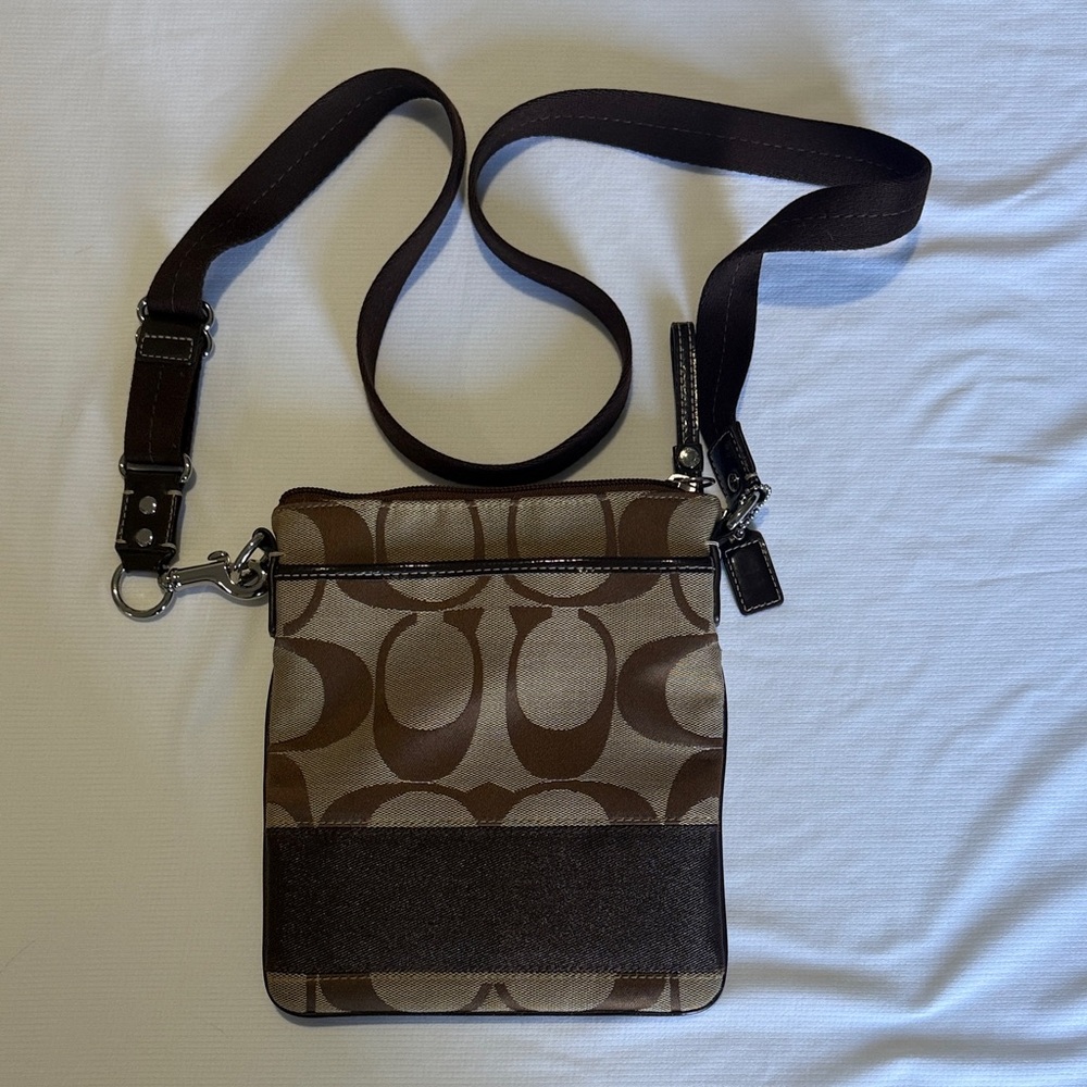 Classic Coach Signature “C” Crossbody Bag in brown and khaki tones.